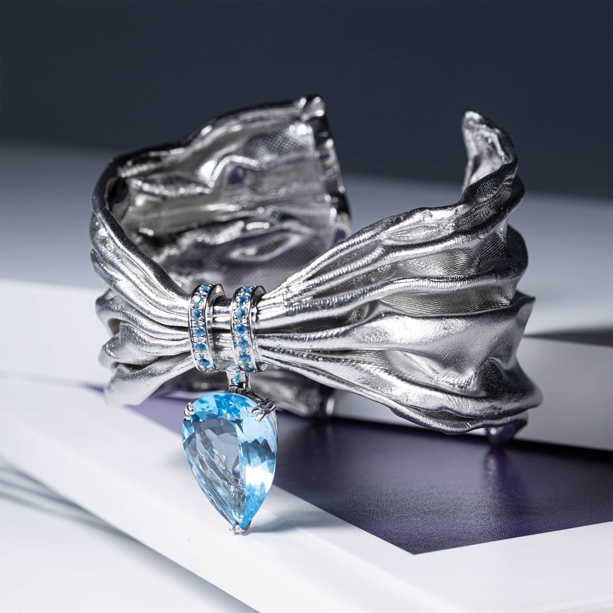 Aegle Silver Bracelet with Blue Topaz and Textured Fabric-Like Surface