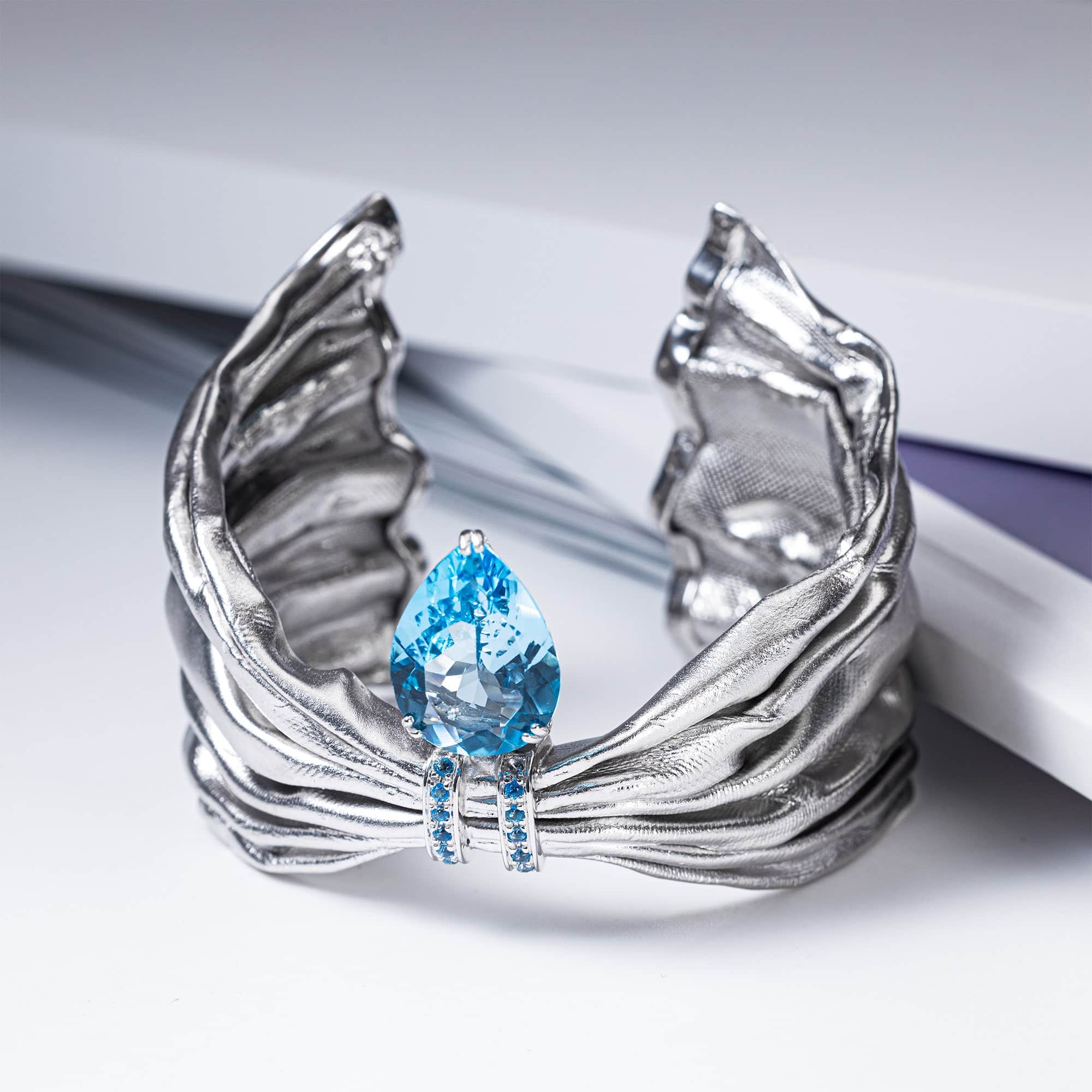 Aegle Silver Bracelet with Blue Topaz and Textured Fabric-Like Surface