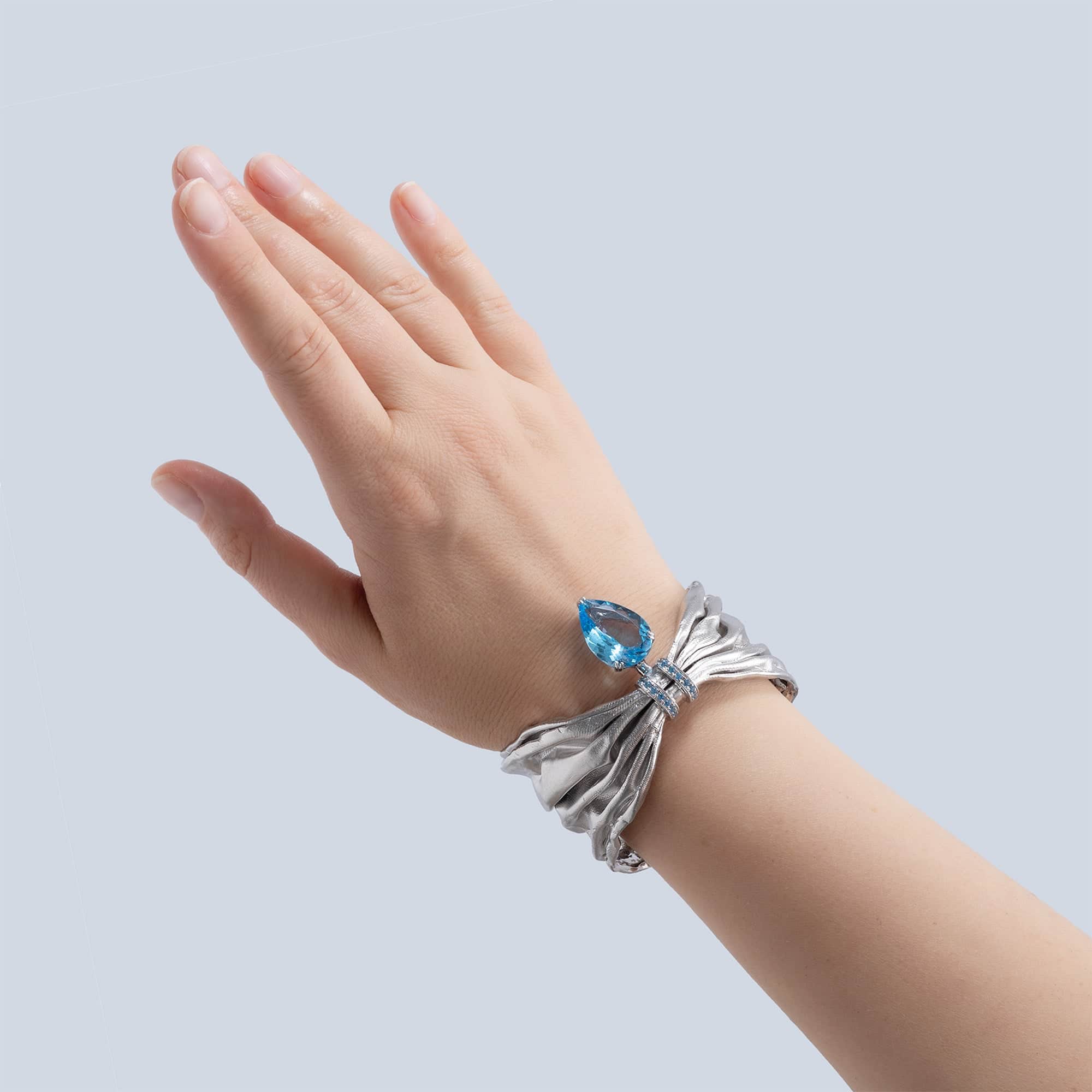 Aegle Silver Bracelet with Blue Topaz and Textured Fabric-Like Surface